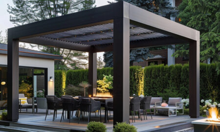 modern pergola in a luxurious backyard covering a beautiful patio set in front of lush bush greenery