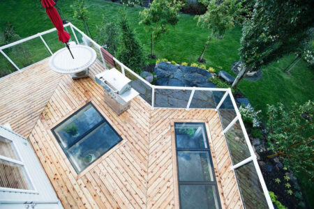 A top-down shot of a second-floor deck with walkable skylights inlaid into the deck