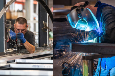 Two men working on drilling and welding various pieces for a glass flooring system