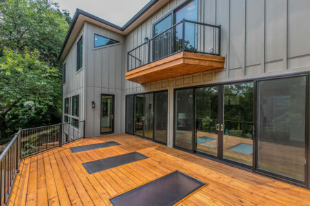 A wooden deck with multiple walkable glass skylights inlaid in them