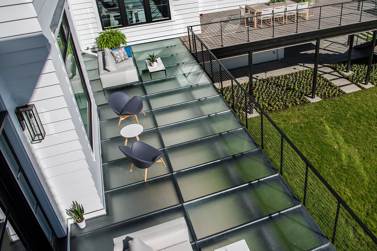 A top-down angle of a deck with frosted glass skylights in the floor