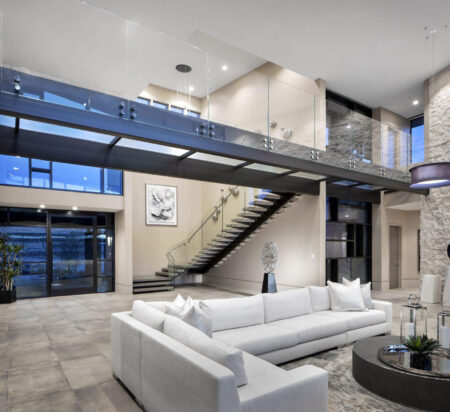 A stylish interior with a glass ceiling providing an expansive outdoor view.