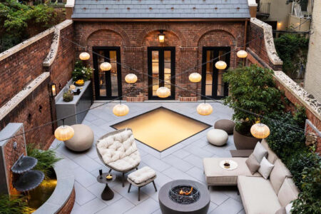 A rooftop showcasing a skylight surrounded by greenery, integrating natural light with sustainable green roof architecture.