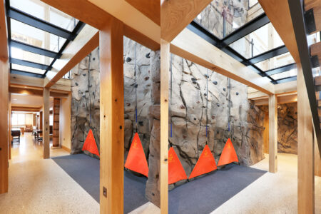 Indoor climbing area with a glass ceiling above, blending natural wood beams and modern glass for a bright and inviting space.