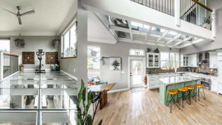 A contemporary kitchen with glass flooring above, allowing natural light to flood the space and creating a bright, open feel.