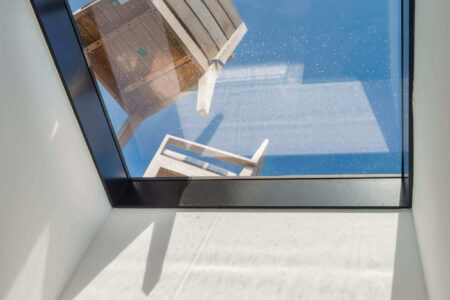 A close-up of a walkable skylight showcasing its transparency and durability, enhancing the flow of natural light into the room below.