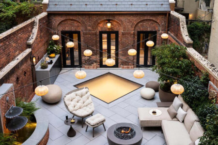 A charming courtyard design with a central glass skylight, providing natural lighting while adding an aesthetic focal point to the outdoor space.