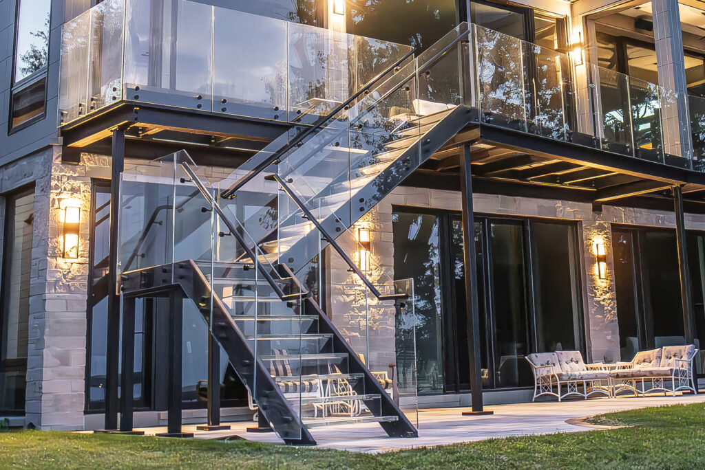 A sophisticated glass staircase integrates seamlessly into this modern home, showcasing transparency and design innovation.