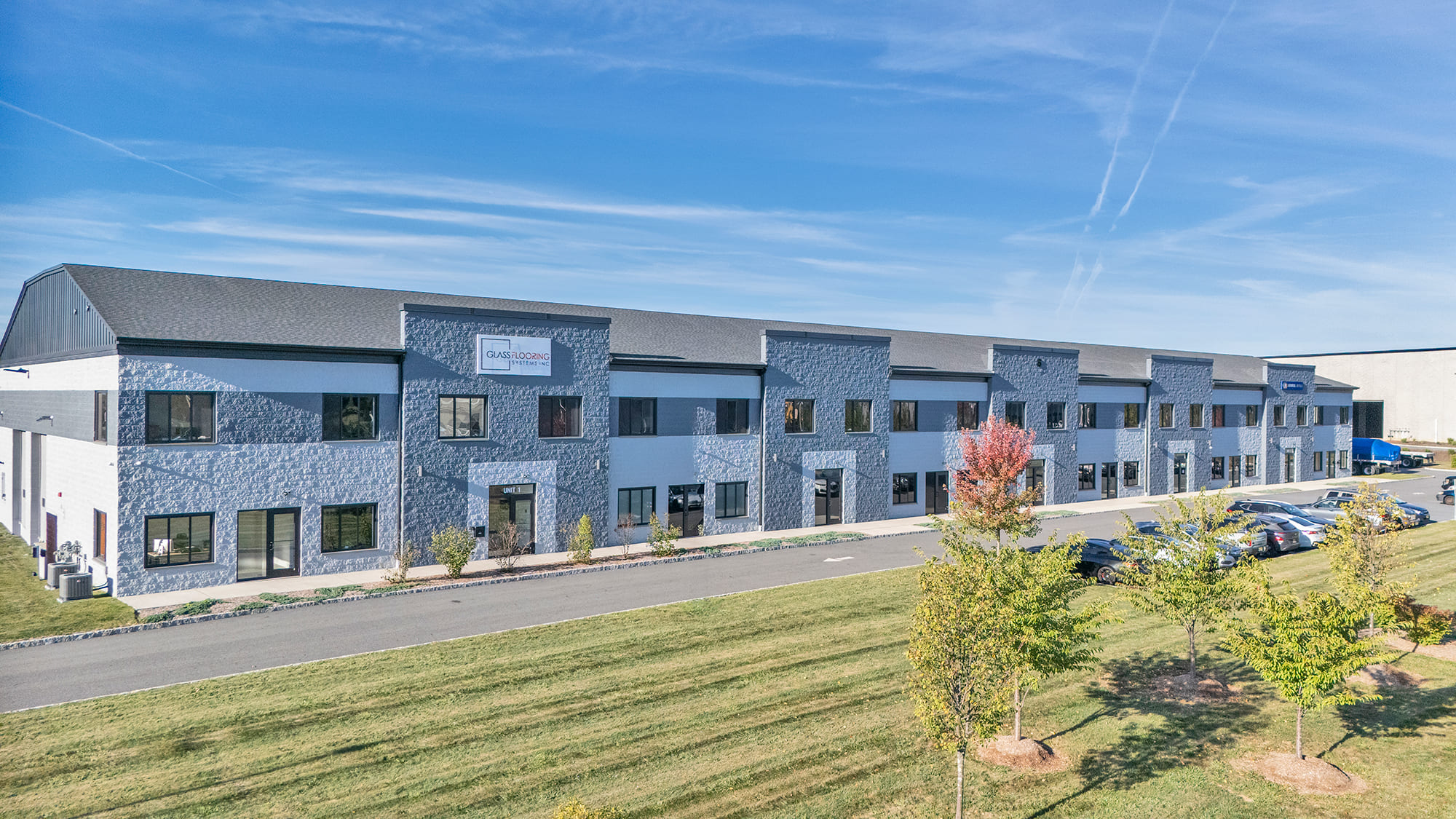 Modern commercial building with sleek glass architecture and landscaped surroundings.
