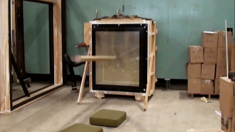 An impact test for a glass panel at a manufacturing site.
