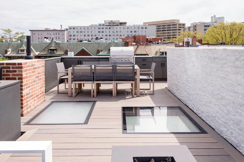 Rooftop patio with flat skylights providing natural light to rooms below.