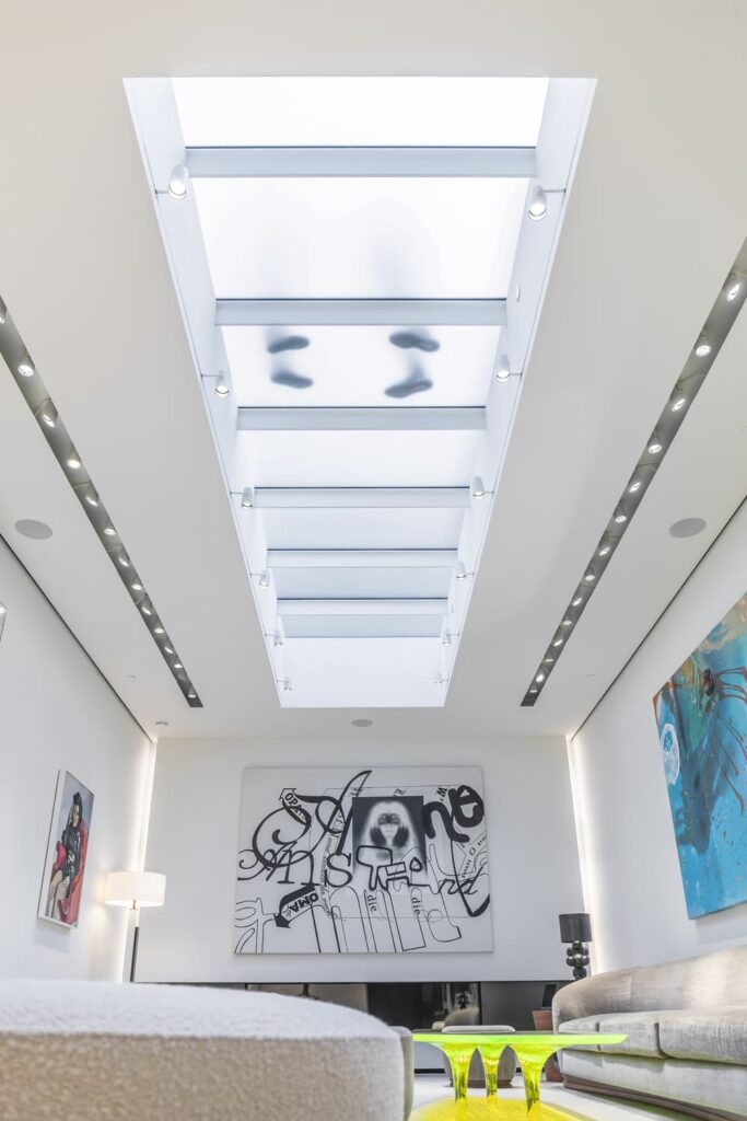 Bright white interior featuring long rectangular skylights illuminating a living area.