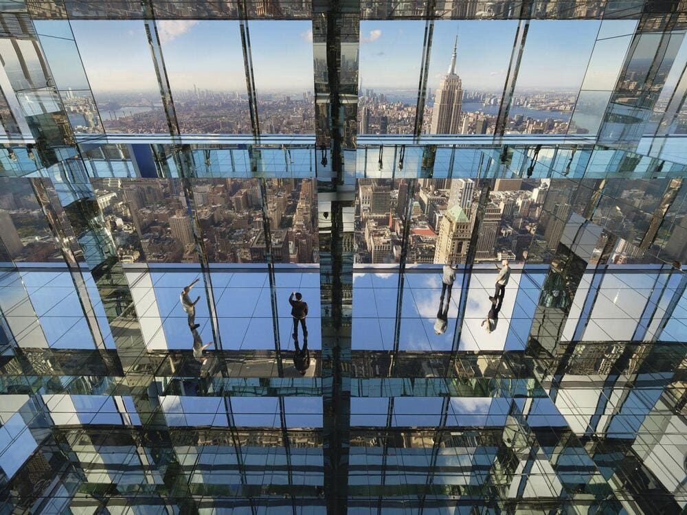 Large-scale glass floor installation showing people walking across transparent tempered glass panels.