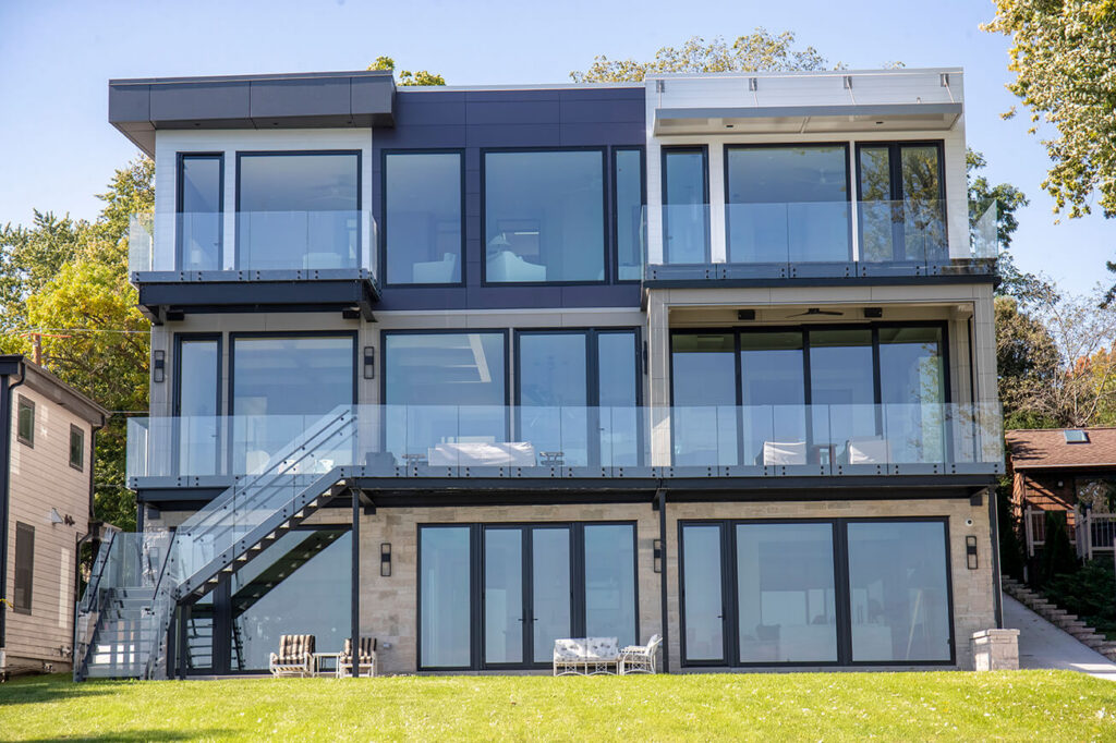 Three-story lakefront residence with a 51-foot structural glass deck, second-story glass balcony and frameless glass railings